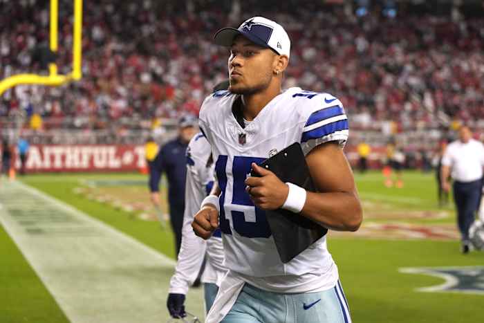 Quarterback Trey Lance jogs off the field during halftime against the San Francisco 49ers